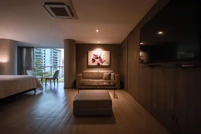 a hotel room with a bed and a couch at Binn Hotel in Medellín