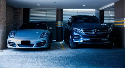 two cars parked in a garage next to each other at Binn Hotel in Medellín