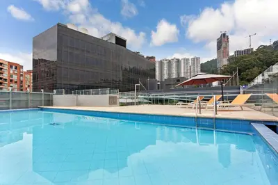 a large swimming pool on top of a building at La Quinta by Wyndham Medellin in Medellín