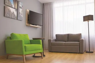 a living room with a couch and a chair at La Quinta by Wyndham Medellin in Medellín