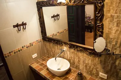 a bathroom with a sink and a mirror at Hotel El Virrey Boutique Honda in Honda