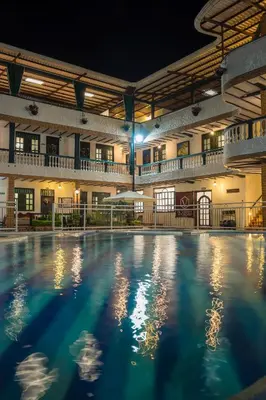 an empty pool in a building at night at Hotel El Virrey Boutique Honda in Honda