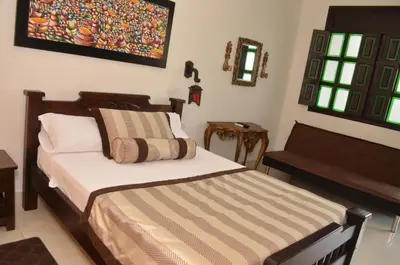 a bedroom with a bed and a couch in it at Hotel El Virrey Boutique Honda in Honda