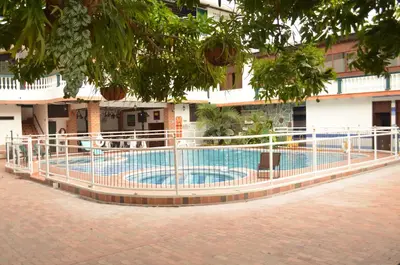 a fence around a swimming pool in front of a building at Hotel El Virrey Boutique Honda in Honda
