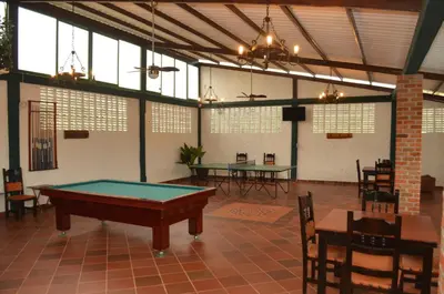 a pool table in a room with tables and chairs at Hotel El Virrey Boutique Honda in Honda