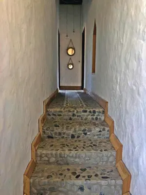a stairway with a light hanging from a wall at Casa Santamaria Hotel Campestre in Jericó