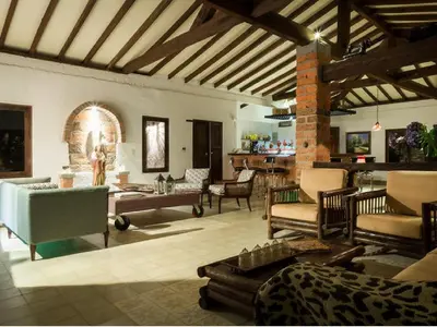 a living room with couches and chairs and a fireplace at Casa Santamaria Hotel Campestre in Jericó