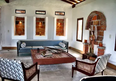 a living room with a couch and a table at Casa Santamaria Hotel Campestre in Jericó