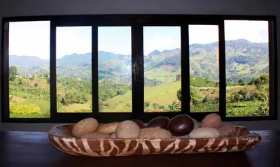 a bowl of rocks on a table in front of a window at Casa Santamaria Hotel Campestre in Jericó
