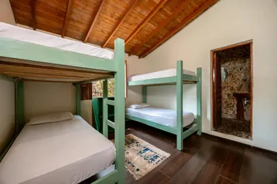 a bedroom with two bunk beds in a room at The Secret Buddha in Medellín