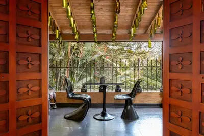 a door with two stools in front of a table at The Secret Buddha in Medellín