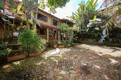 a duck is sitting in the courtyard of a house at The Secret Buddha in Medellín