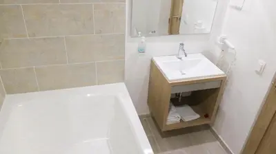 a bathroom with a sink and a bath tub and a sink at Hotel Boutique Laureles Medellin (HBL) in Medellín