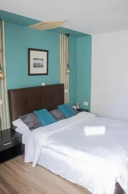a bedroom with two beds with blue walls at Apartahotel Millennials in Manizales