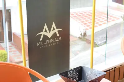 a sign for a millimallsynchronousproduct sitting on a table with a box at Apartahotel Millennials in Manizales