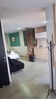 a living room with a couch and a kitchen at Apartahotel Millennials in Manizales