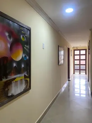 a hallway with a large painting on the wall at Hotel Caldas Plaza in Caldas