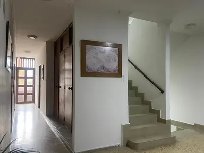 a hallway with stairs and a painting on the wall at Hotel Caldas Plaza in Caldas