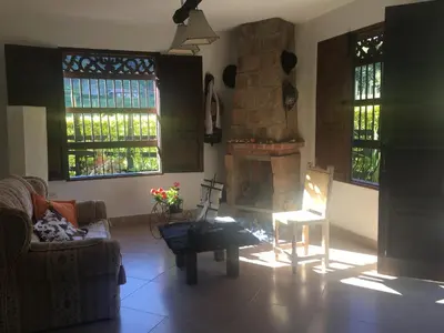 a living room with a couch and a fireplace at Casa Hotel Portón Campestre in Jardin
