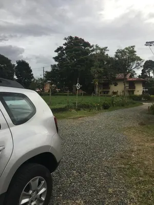 a white car parked on the side of a road at Casa Hotel Portón Campestre in Jardin