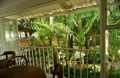 a screened in porch with a table and chairs at Alojamiento rural el Refugio en santagueda in Santagueda