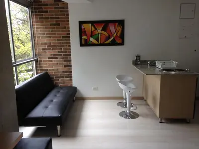 a living room with a couch and a table at San Peter Suites in Medellín