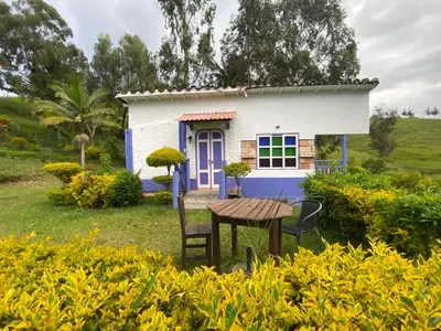 a tiny house with a table in front of it at Cabañas y Flores in Jericó