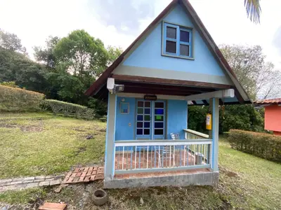a small blue house with a gambrel roof at Cabañas y Flores in Jericó