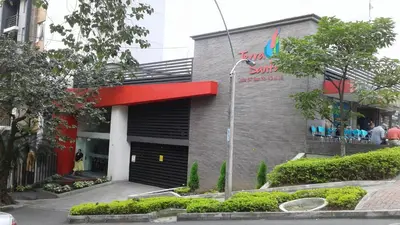 a building with a sign on the side of it at Apartamento En Sabaneta in Sabaneta