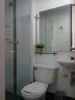 a bathroom with a toilet and a sink at Apartamento En Sabaneta in Sabaneta