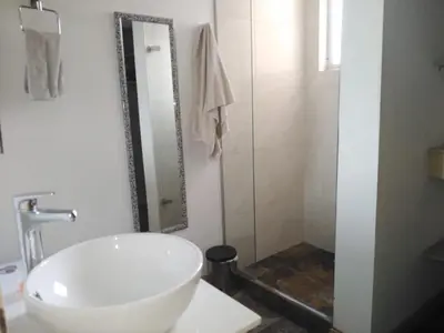 a bathroom with a white sink and a mirror at San Peter Apartments in Medellín