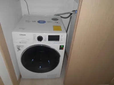 a washing machine sitting in a room next to a door at San Peter Apartments in Medellín