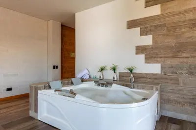 a bath tub in a room with wooden walls at Terra Biohotel in Medellín