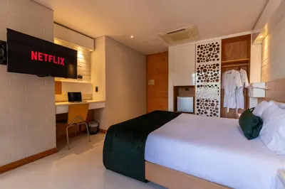 a hotel room with a bed and a television at Terra Biohotel in Medellín