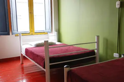 a bedroom with two bunk beds and a window at Golden Frog Manizales in Manizales