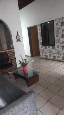 a living room with a table and a fireplace at Amoblado centro de la Moda in Itagüí
