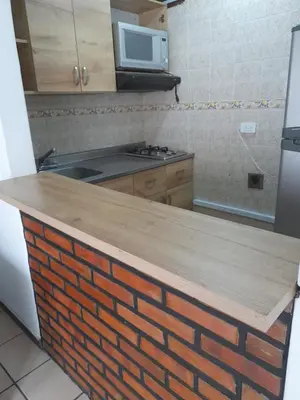 a kitchen with a brick counter top in a kitchen at Amoblado centro de la Moda in Itagüí