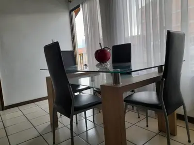 a dining room table with black chairs and an apple on it at Amoblado centro de la Moda in Itagüí