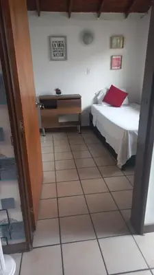 a bedroom with a bed and a desk on a tiled floor at Amoblado centro de la Moda in Itagüí