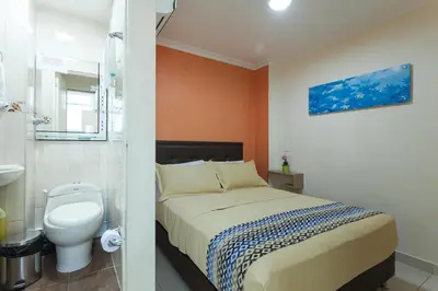 a bathroom with a bed and a toilet in a room at Apartamentos Laureles de la 70 in Medellín