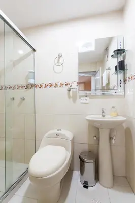 a bathroom with a toilet and a sink at Apartamentos Laureles de la 70 in Medellín