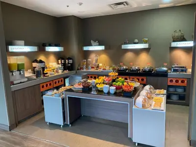 a buffet line with fruits and vegetables on a table at Hampton by Hilton Medellin in Medellín