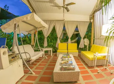 a living room with yellow chairs and a table at Casamarilla in Mariquita