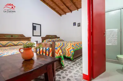 a living room with a vase on a wooden table at Hotel La Casona in Jardin