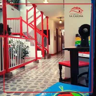 a room with a red staircase with a red railing at Hotel La Casona in Jardin