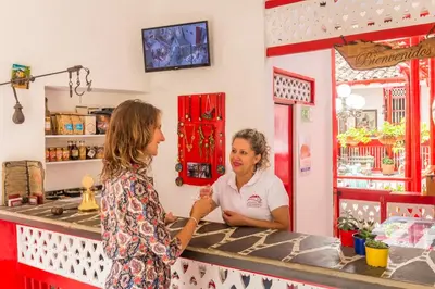 two women standing at a counter in a store at Hotel La Casona in Jardin