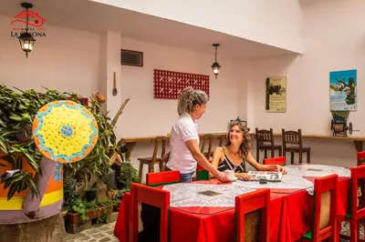a man and woman sitting at a table in a restaurant at Hotel La Casona in Jardin