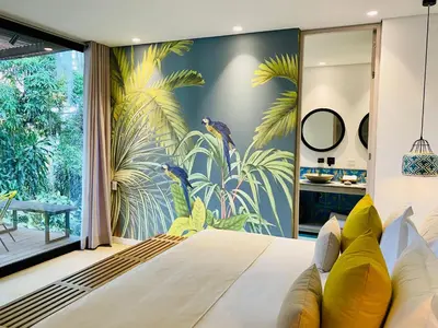 a bedroom with a mural of tropical plants at Patio del Mundo in Medellín