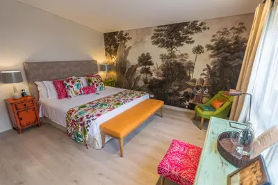 a bedroom with a bed and a table and a couch at Patio del Mundo in Medellín