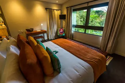 a bedroom with a large bed with a large window at Patio del Mundo in Medellín